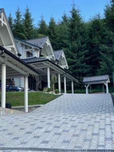 a row of houses with a brick driveway at WhiteWood Cottages in Bukovel