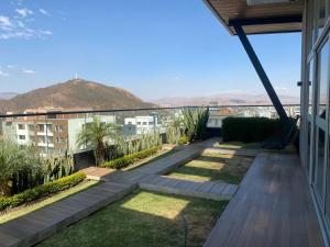 a view from the balcony of a house with a garden at Garden Suite in Cochabamba