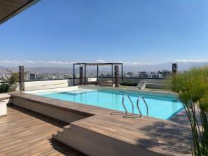 a swimming pool on the roof of a house at Garden Suite in Cochabamba