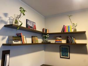 a room with two wooden shelves with books at Garden Suite in Cochabamba