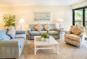 a living room with couches and a coffee table at Pointe Santo D27 condo in Sanibel