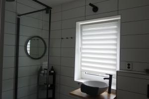 a window in a bathroom with a toilet and a sink at Apartmán HARMONY - Lipno nad Vltavou in Lipno nad Vltavou +35 photos
