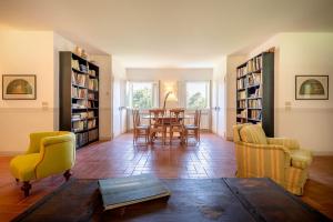a living room with a table and chairs and bookshelves at Agriturismo Lemene in Caorle