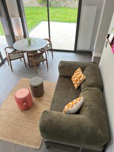 a living room with a couch and a table at Ancien Pigeonnier Centre-Ville historique de Vesoul Bain nordique Terrasse Jardin Animaux bienvenus in Vesoul +62 photos