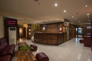 a hotel lobby with a reception desk and leather furniture at Hotel Lira in Sunny Beach +35 photos