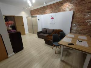 a living room with a couch and a table at 1904 Loft in Świnoujście