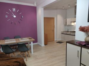 a kitchen with a table and a clock on the wall at 1904 Loft in Świnoujście +17 photos