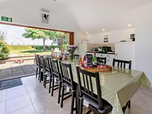 a dining room with a table and chairs and a kitchen at 6 bed in Buckland Brewer 75553 in Buckland Brewer