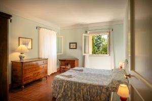 a bedroom with a bed and a dresser and a window at Agriturismo Lemene in Caorle +60 photos