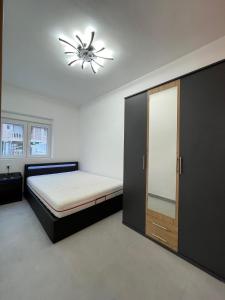 a bedroom with a bed and a chandelier at Flor De Sal Villa in San Pedro del Pinatar