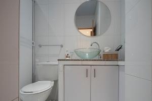 a bathroom with a toilet and a sink and a mirror at edificio Alba in Cartagena de Indias +9 photos
