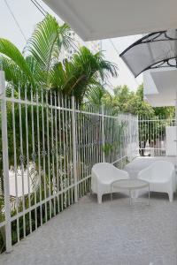 a white fence with two chairs and a table at edificio Alba in Cartagena de Indias
