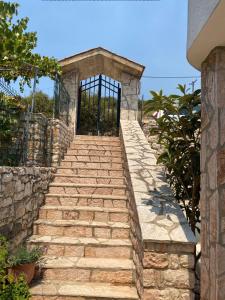 a set of stone stairs leading to a door at Berti Apartaments in Sarandë +2 photos