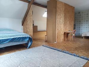 a bedroom with a bed and a table in a room at Maison De Vacances 