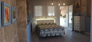 a bedroom with a bed and a dresser at Cal Ton de la Rosa de Castelldans in Castelldáns