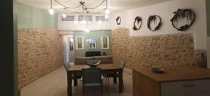 a kitchen and dining room with a table and chairs at Cal Ton de la Rosa de Castelldans in Castelldáns +18 photos