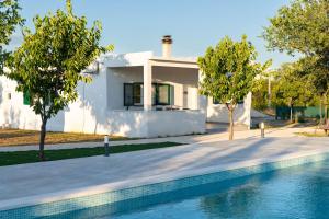 a house with a swimming pool in front of a house at Kuća za odmor Matetić in Unešić