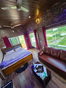 a bedroom with a bed and a couch in a room at Barla's Home Stay in Hyderabad