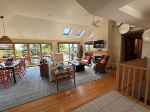 a living room filled with furniture and a table at Bayberry Beach House in Provincetown