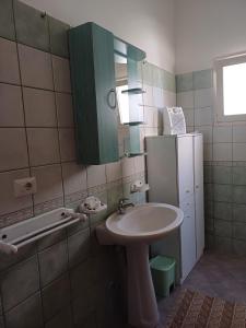 a bathroom with a sink and a green cabinet at dimora relax MICHELA in Galatina
