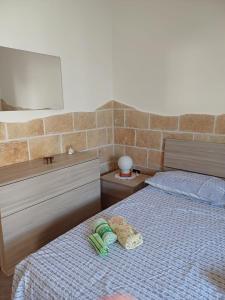 a bedroom with a bed with two towels on it at dimora relax MICHELA in Galatina +8 photos