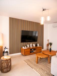 a living room with a flat screen tv on a wall at El Pirata 78 in Estepona