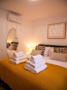 a hotel room with two beds with towels on the bed at El Pirata 78 in Estepona