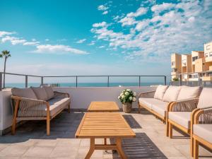a patio with two couches and a table on a balcony at El Pirata 78 in Estepona