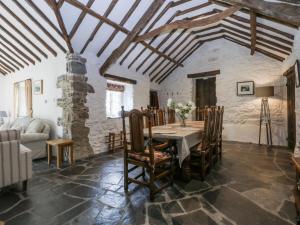 a dining room with a table and chairs at Tyddyn Iolyn in Benllech