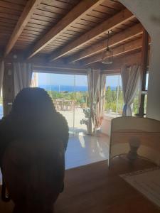 a living room with a view of the ocean at Esclusiva villa nella natura vista mare e tramonti in Marina di Sorso +20 photos