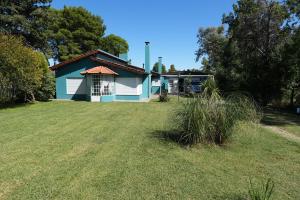 a blue and white house with a large yard at Barrio Patagonia * Bahía Blanca in Bahía Blanca