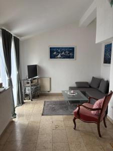 a living room with a couch and a table at Apartments Kristic in Lovran