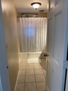 a hallway with a shower with a white curtain at Best Deal-8 beds- Perfect for large Team in Willmar