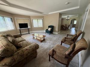 a living room with a couch and chairs and a television at Best Deal-8 beds- Perfect for large Team in Willmar +65 photos