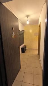 a hallway with a door and a tile floor at Planorama Family relax in Bucharest +4 photos