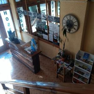 a living room with a couch and a clock on the wall at HABITACION FAMILIAR 4 PERSONAS PRIVADa in San Carlos de Bariloche