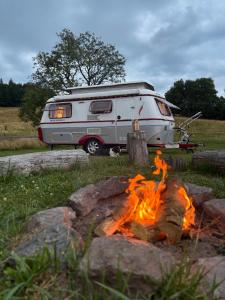 a camper is parked next to a camp fire at Red hot čili Romance in Kounov