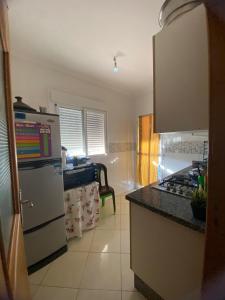 a kitchen with a white refrigerator and a stove at شقة جاردينيا - طنجة البالية in Tangier