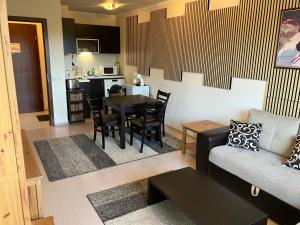 a living room with a couch and a table at Borovets Gardens apartment C-43 in Borovets