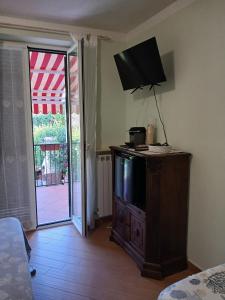 a television on top of a dresser in a room at Imperiale in Sarzana