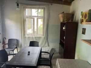 a dining room with a table and chairs and a window at OK Sakhli VIP in Shekhvetili