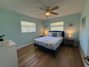 a bedroom with a bed and a ceiling fan at Turtle Cove Beach House in Cape Coral +23 photos
