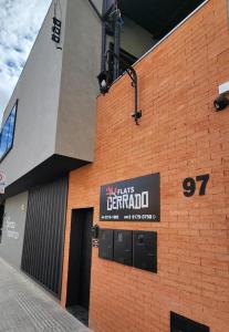 a building with a sign on the side of it at FLATS CERRADO santa casa in Montes Claros