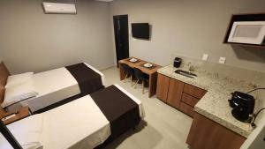 a hotel room with a bed and a sink at FLATS CERRADO santa casa in Montes Claros