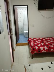 a room with a bed and a bathroom with a toilet at Hospedaje el balcon suite in Villavicencio