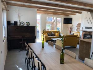 a living room with a table and yellow furniture at Jako doma in Ivaň
