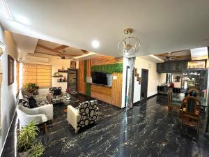 a living room with a couch and a tv at Hasa-Nibas in Bhubaneshwar