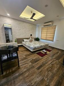 a bedroom with a bed and a wooden floor at Hasa-Nibas in Bhubaneshwar