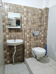 a bathroom with a sink and a toilet at Hasa-Nibas in Bhubaneshwar