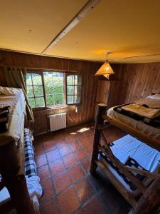 a room with two bunk beds in a cabin at Periko´s Youth Hostel in San Carlos de Bariloche